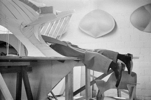The photo of eero saarinen waist-deep in his model of the twa terminal at idlewild (now jfk airport) captures the essence of his hands-on approach to architecture in the late 1950s. Saarinen, renowned for his innovative designs, was commissioned by twa in 1955 to create a terminal that embodied the spirit of the jet age. The twa terminal, completed in 1962, features sweeping, bird-like concrete shells that symbolize flight and modernity. Working within the large-scale model allowed saarinen to meticulously refine the spatial dynamics and structural elements of the terminal. His design philosophy aimed to seamlessly blend form and function, creating a fluid, open interior space filled with natural light. This model was crucial in visualizing the complex curves and innovative structure that defined the terminal. © balthazar korab