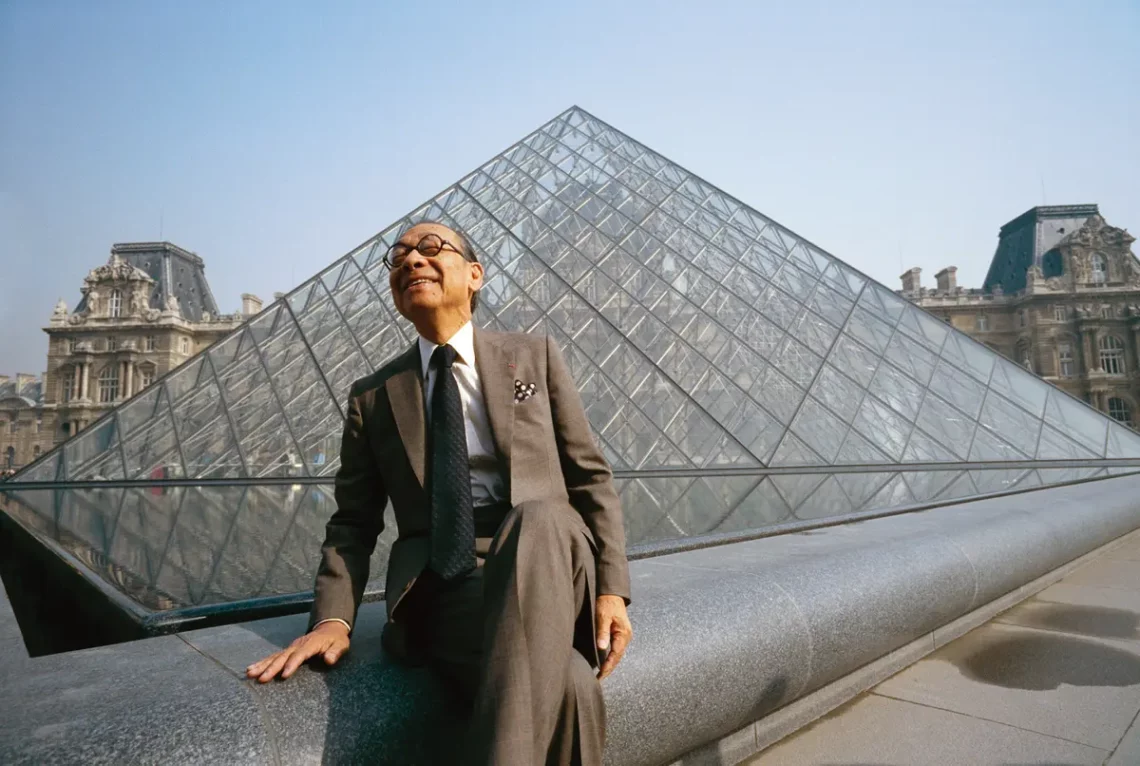 I. M. Pei standing before one of his most iconic creations, the louvre pyramid in paris - © bernard bisson
