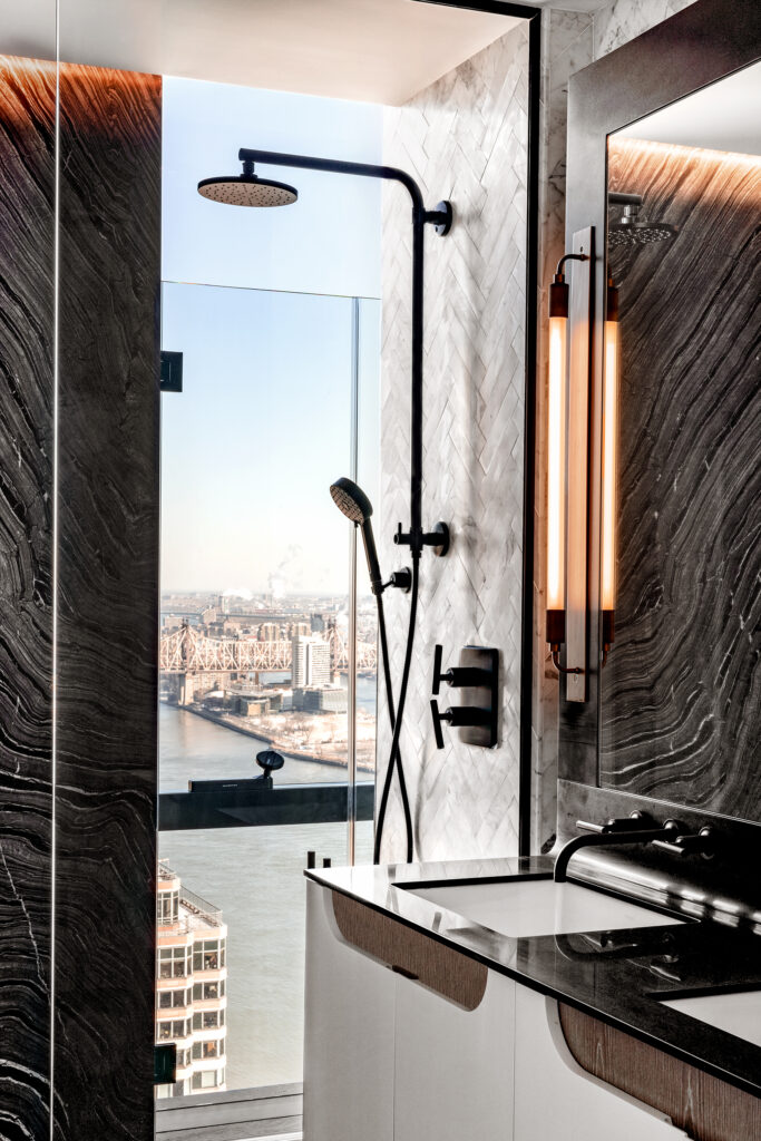 Cove lighting in american copper's shower: a soft glow highlighting the stone wall. © krista ninivaggi