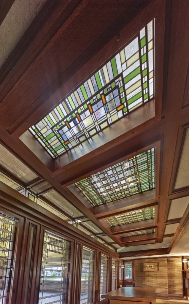 Restored veranda doors at the east end of the living room, where natural light filters through Wright's restored art glass skylight above. © Biff Henrich