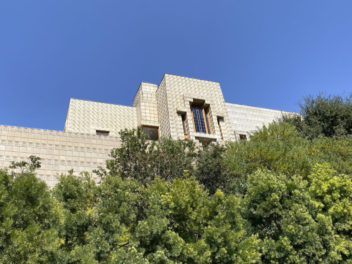 South-facing facade of ennis house rises over thick foliage cultivated for privacy, yet it remains a draw for curious onlookers and reporters. © rachel presser